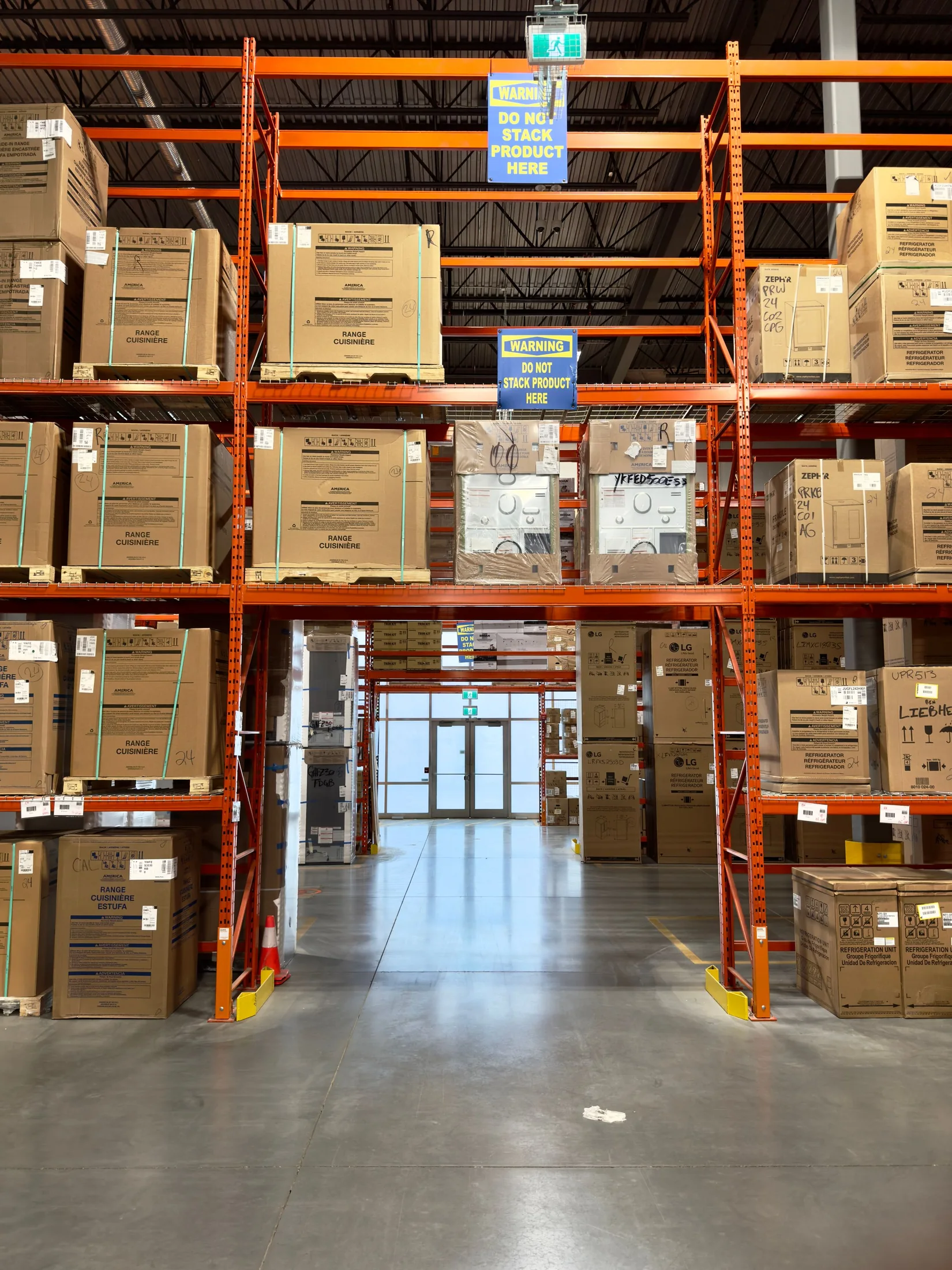 Warehouse aisle lined with pallet racks and boxed goods